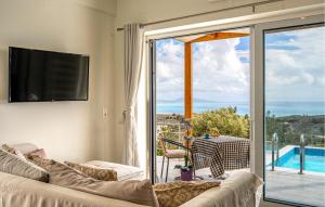 a living room with a couch and a sliding glass door at Daphne 2 in Agia Galini