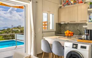 a kitchen with a view of a pool at Daphne 2 in Agia Galini