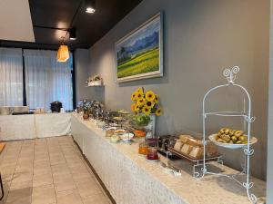 a kitchen with a counter with food and flowers on it at WE Valley Hotel in Chiang Mai +36 photos