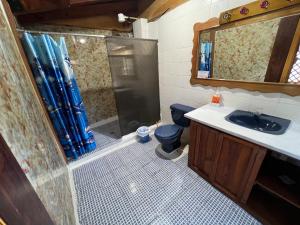 a bathroom with a shower and a toilet and a sink at Mansión Del Arco in San Pedro La Laguna +29 photos