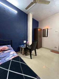 a bedroom with a bed and a chair and a table at Sky cottage in Jāmb