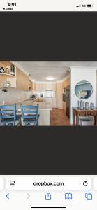 a kitchen with two blue chairs in a room at 3 Mile in Lennox Head