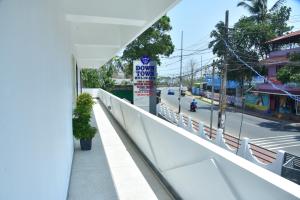 a view of a street from a balcony with a sign at DOWN TOWN HOLIDAYS Kovalam in Kovalam