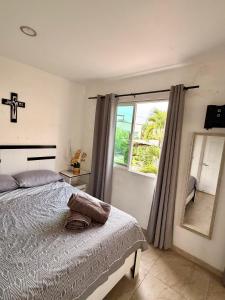 a bedroom with a bed and a large window at Casa con terraza frente alberca in Tezoyuca +39 photos