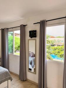 a bedroom with a view of a bed and a mirror at Casa con terraza frente alberca in Tezoyuca
