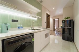 a kitchen with a sink and a dishwasher at Nina Sky Serviced Apartment in Ho Chi Minh City