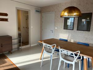 a dining room with a wooden table and chairs at Dcondo Creek Phuket 2BR in Kathu