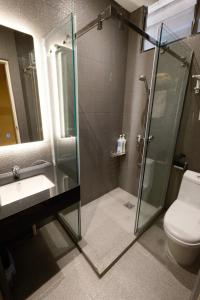 a bathroom with a shower and a sink and a toilet at Hotel Ming Star in Kuala Terengganu