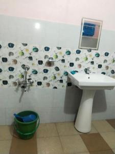 a bathroom with a sink and a mirror at Urisha homestay in Mawlynnong
