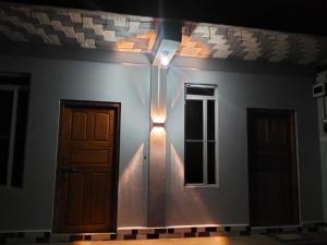 a room with a door and two windows at Urisha homestay in Mawlynnong