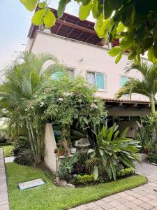 a house with plants in front of it at Casa con terraza frente alberca in Tezoyuca
