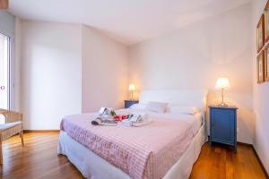 a bedroom with a large bed with a table on it at La Maison du Bonheur with Shared Pool & Sauna - Happy Rentals in Aldesago