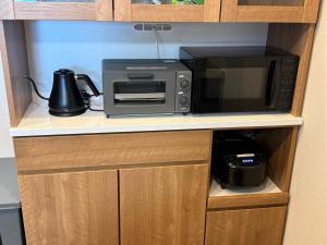 a microwave oven sitting on top of a counter at Private house 海Kai in Nagato