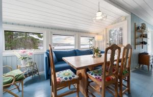 a dining room with a table and chairs at Nice Home In Risør With House Sea View in Risør
