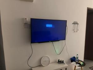 a flat screen tv hanging on a wall at DF Homestay in Kangar