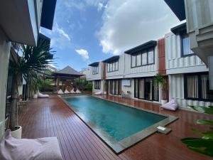 a swimming pool in the courtyard of a building at Allende Canggu in Canggu