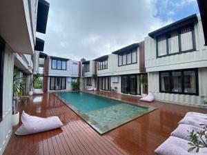 a swimming pool in the middle of a building at Allende Canggu in Canggu