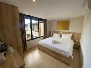 a bedroom with a bed with a teddy bear on it at Allende Canggu in Canggu +9 photos