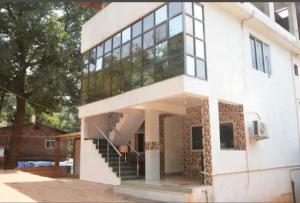 a large white building with a staircase in front of it at Sky cottage in Jāmb