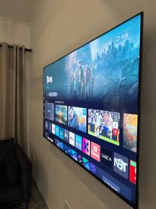 a large flat screen tv hanging on a wall at 127 Clarens Golf Villa in Clarens