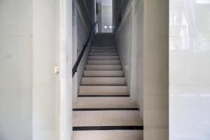 a staircase in a building with black and white floors at Townhouse Oak Su's Cottage Near Legian Beach in Legian