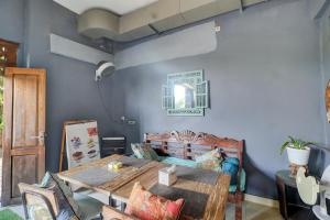 a dining room with a table and a blue wall at Townhouse Oak Su's Cottage Near Legian Beach in Legian