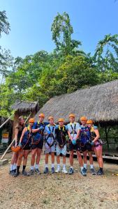 a group of people are posing for a picture at Namdong Waterfall & Eco Resort in Luang Prabang