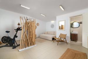 a white living room with a couch and a chair at Villa Aristoteles in Lindos