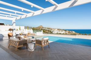 a villa with a swimming pool and a patio at Villa Aristoteles in Lindos