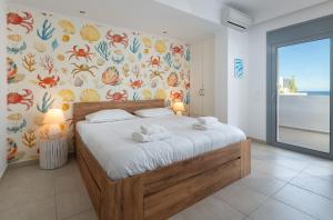 a bedroom with a bed with towels on it at Villa Aristoteles in Lindos +11 photos