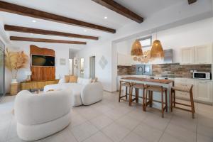 a kitchen and living room with a couch and a table at Villa Aristoteles in Lindos