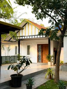 a house with a tree in front of it at SRK luxe resort in Maivādi Road