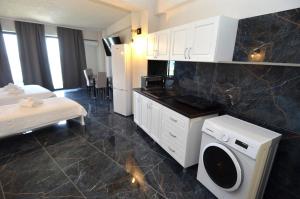 a hotel room with a bed and a washing machine at Diamonds in the Sky in Costinesti