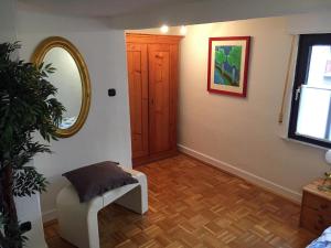 a room with a mirror and a chair and a door at Ferienhaus FachWerk in Holler