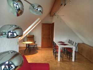 a dining room with a white table and chairs at Ferienhaus FachWerk in Holler