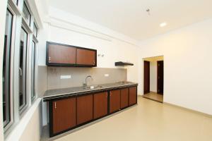 a kitchen with a sink and a counter top at Hotel Emerald Green in Weligama
