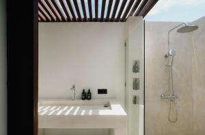 a bathroom with a sink and a shower at Limbo Lux Bungalows in Kuta Lombok +15 photos