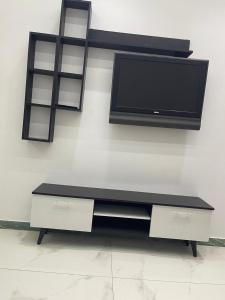 a flat screen tv on a wall with a shelf at 6th october luxury studio 2 in 6th Of October