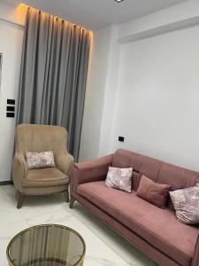 a living room with a couch and a chair at 6th october luxury studio 2 in 6th Of October