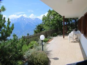 a patio with a view of the mountains at Sunny chalet in Veysonnaz for 10 guests in Veysonnaz +125 photos