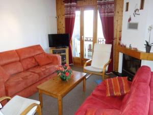 a living room with a couch and a table at Cozy apartment for groups in Veysonnaz +100 photos