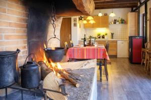 a kitchen with a pot on a stove with a fire at Ca Brunella 2 Lake Maggiore View Terrace for Four - Happy Rentals in Riazzino
