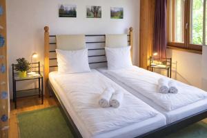 a bedroom with a bed with white sheets and slippers at Ca Brunella 2 Lake Maggiore View Terrace for Four - Happy Rentals in Riazzino +17 photos