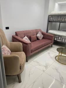 a living room with a couch and two chairs at 6th october luxury studio 2 in 6th Of October