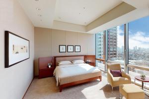 a bedroom with a bed and a large window at Grand Hyatt Tokyo in Tokyo