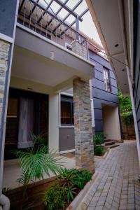 a house with a balcony and a patio at Vine Suites Mbarara - 1 Bed Studio Apartment Near LDC & City Centre - Quiet & Convenient in Mbarara