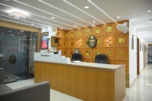 a restaurant with a counter and chairs in a lobby at Hotel Heritage Prime Junagadh in Junagadh