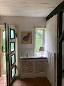 a room with a window and a table with a lamp at Haus Siebenstein Living for a good cause in Drochtersen