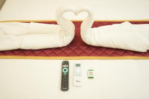 a room with two swans and a remote control at La Coral Residency in Pondicherry