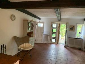 a kitchen with a table and a chair in a room at Haus Siebenstein Living for a good cause in Drochtersen
